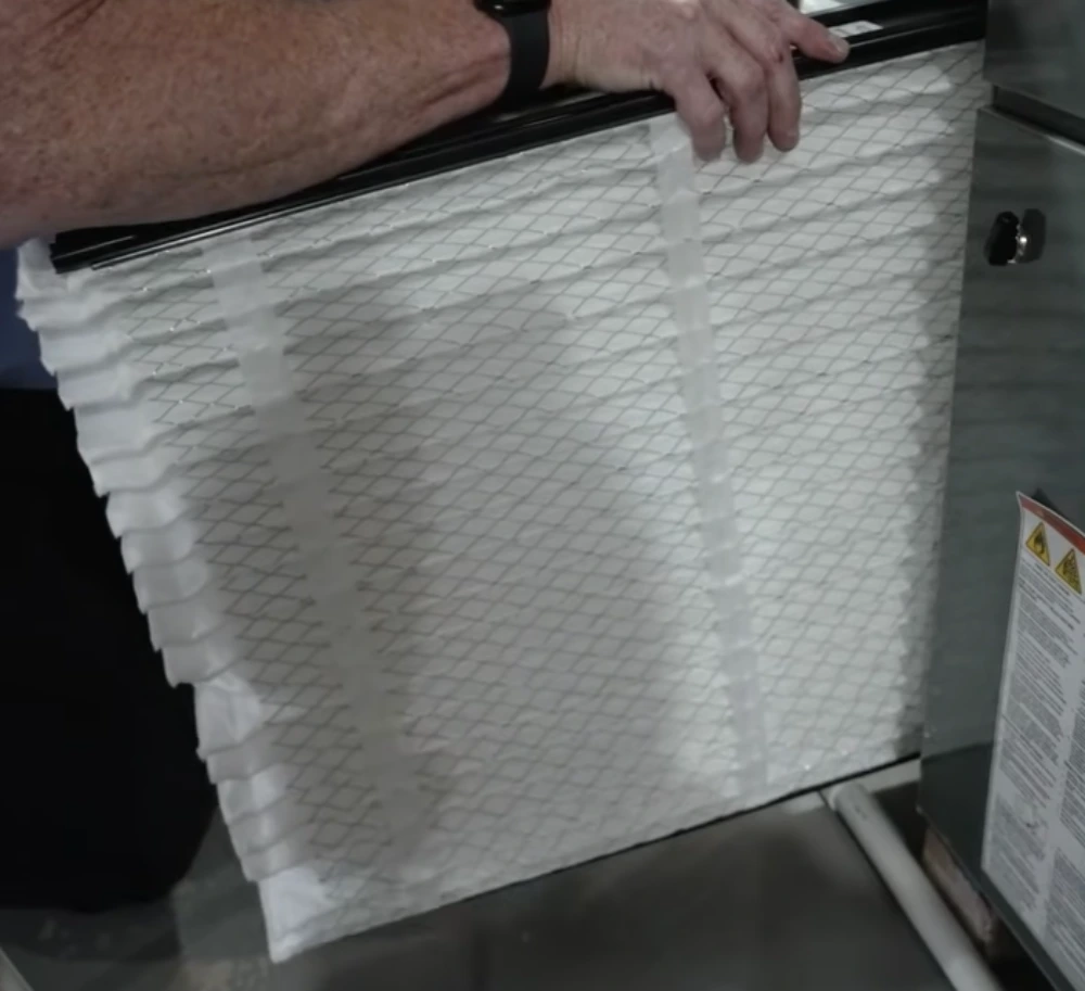 Technician inspecting an air filter as part of duct sanitizing service in Tampa