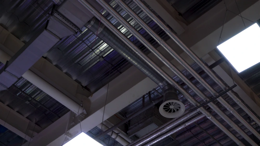 Air duct cleaning technician inspecting ductwork material and condition