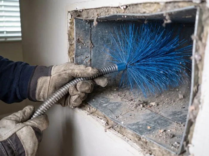 Rotary brush agitation cleaning ductwork during a Tampa air duct service