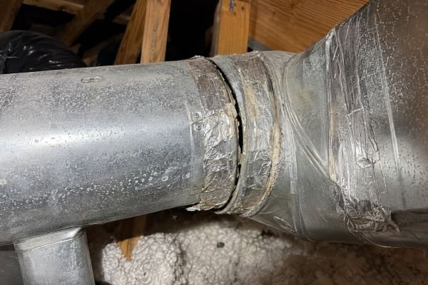 Sealed metal duct connection point showing proper sealing versus degraded tape in a Tampa home